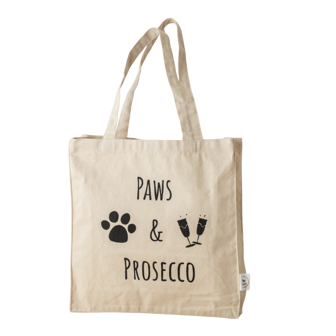 Park Life Designs Paws and Prosecco Tote Bag in natural canvas with black text and graphics