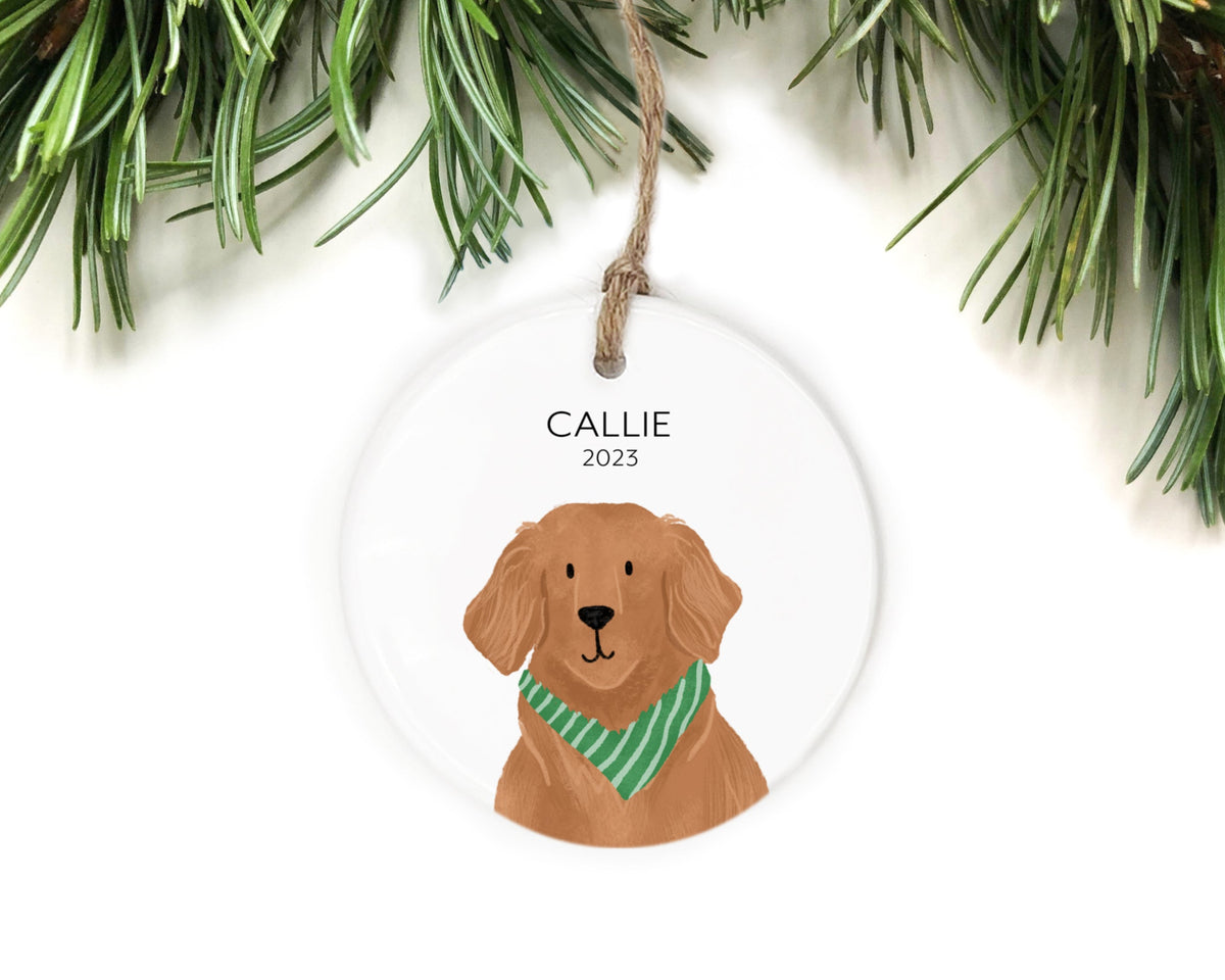 White ceramic ornament with a golden retriever wearing a green striped bandana, name Callie and year 2023