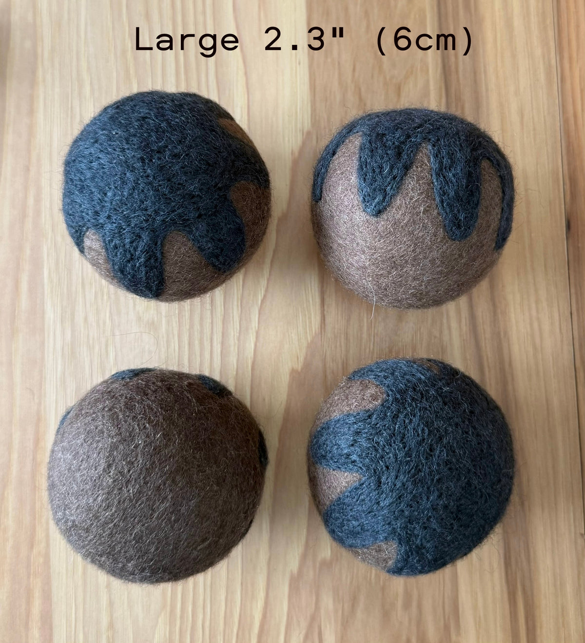 Four large 2.3 inch (6cm) Whiskers n' Paws Felt Balls, brown with dark blue patterns