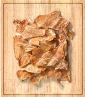 4 Paws Butcher Shop jerky pieces on a wooden surface -