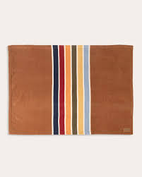 Brown blanket with vertical stripes in red, orange, yellow, blue, and white