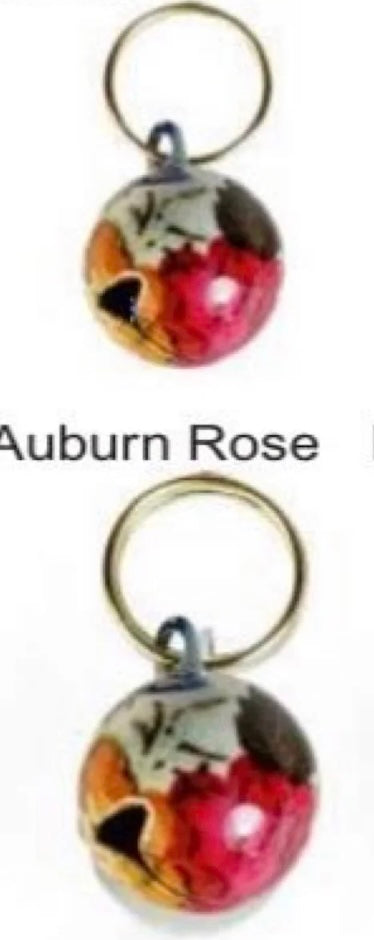 Two Auburn Rose color pet bells with a gold ring at the top