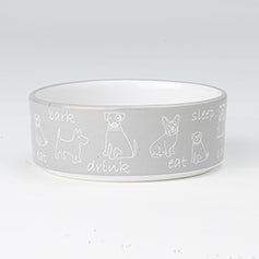 Grey ceramic dog bowl with white line drawings of dogs and words like bark, drink, eat, sleep