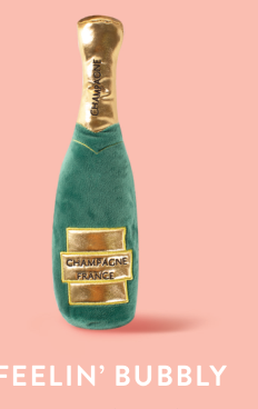 Green plush dog toy shaped like a champagne bottle with gold accents and the words Champagne France