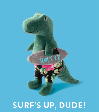 Green dinosaur plush toy wearing floral swim trunks and holding a grey surfboard that says SURF'S UP