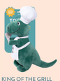 Fringe Studio BBQ Rex-Plush Dog Toy, a green dinosaur wearing a chef hat and apron, holding a spatula