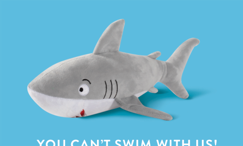 Grey shark plush toy with white belly and red mouth detail