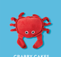 Red plush crab toy with white eyes on a blue background