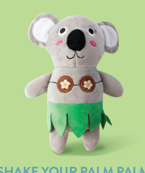 Koala plush toy wearing a green hula skirt and a brown coconut shell bra