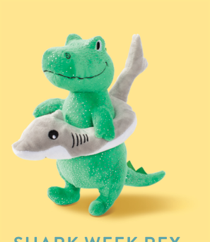 Green plush dinosaur wearing a grey shark-shaped inner tube