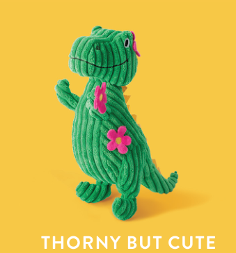 Green corduroy dinosaur toy with pink flowers