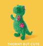Green corduroy dinosaur toy with pink flowers