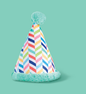 Colorful party hat with a chevron pattern and a teal pom-pom on top