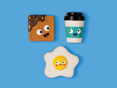 Waffle, coffee cup, and fried egg shaped baby teethers with cartoon faces