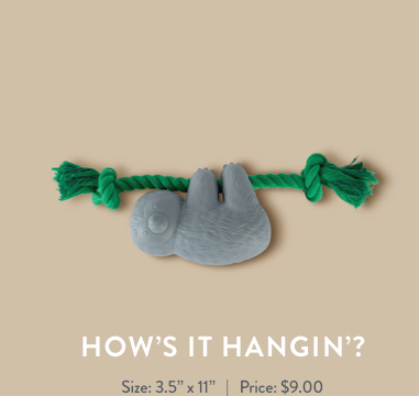 Grey sloth toy hanging from a green rope