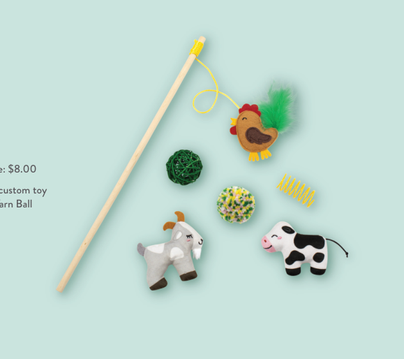 A cat toy set including a wand, a chicken, a goat, a cow, and two yarn balls