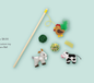 A cat toy set including a wand, a chicken, a goat, a cow, and two yarn balls