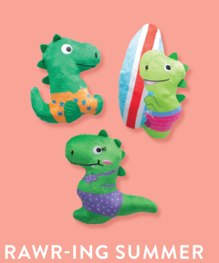 Three green dinosaur plush toys in swimsuits with a surfboard
