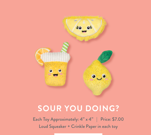 Three lemon-themed plush dog toys on a pink background
