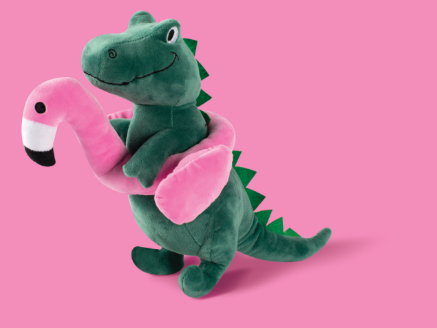 Green plush crocodile with a pink flamingo float around its neck