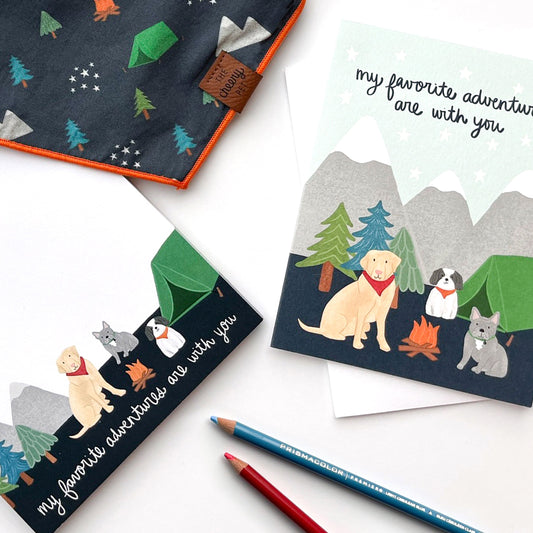Two Cheery Pet greeting cards and a bandana with a camping theme, with two colored pencils