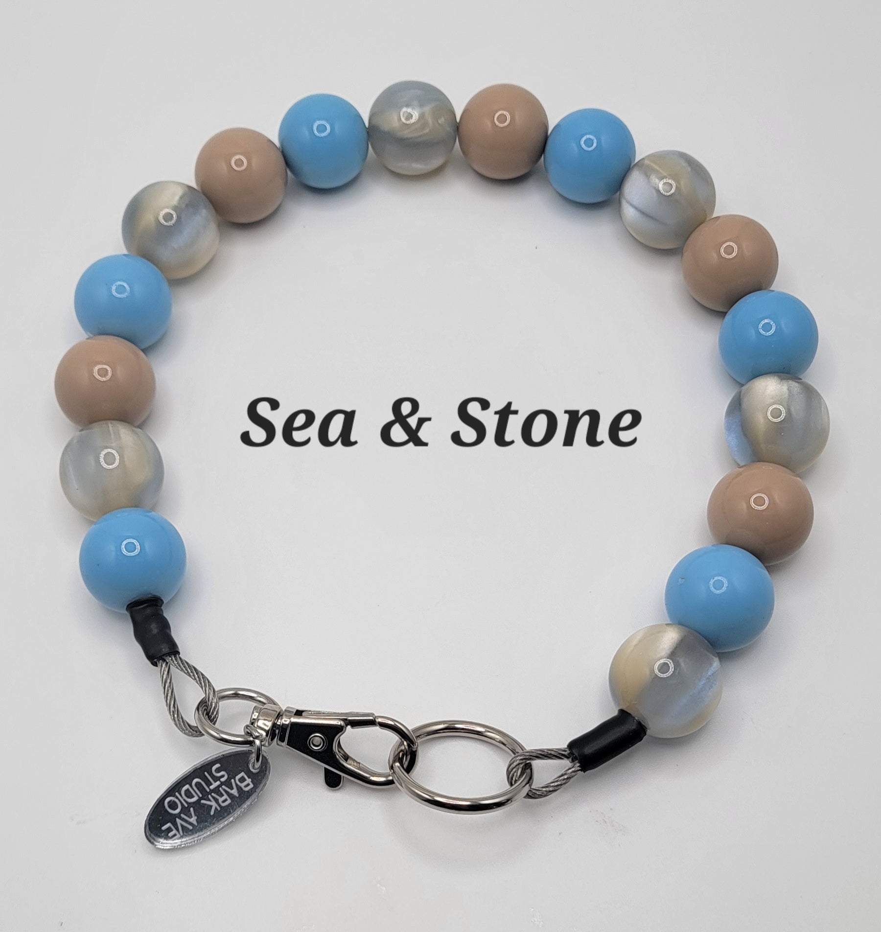 Sea & Stone beaded dog collar with blue, tan, and marbled beads, Bark Ave Studio tag
