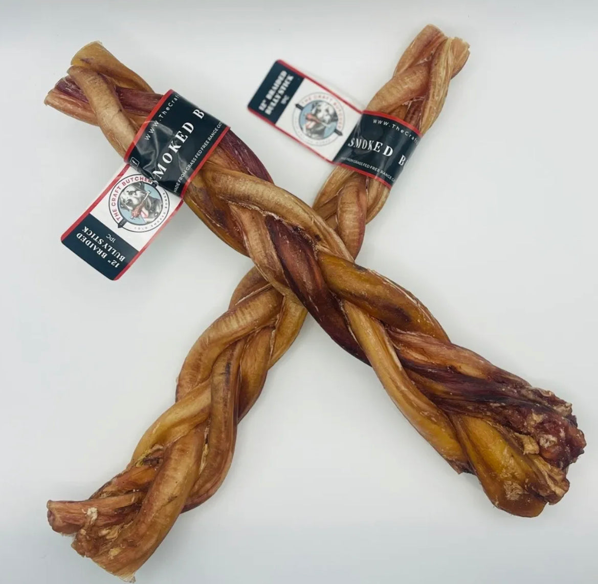 Two 12-inch braided bully sticks from The Craft Butcher, arranged in an X shape