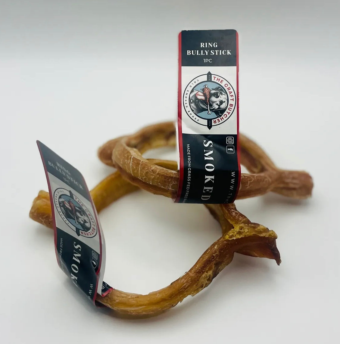 Two smoked ring bully sticks with The Craft Butcher brand labels
