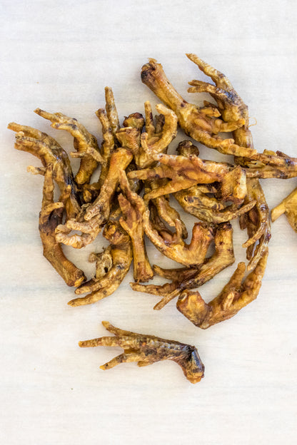 Pile of dried chicken feet on a light background