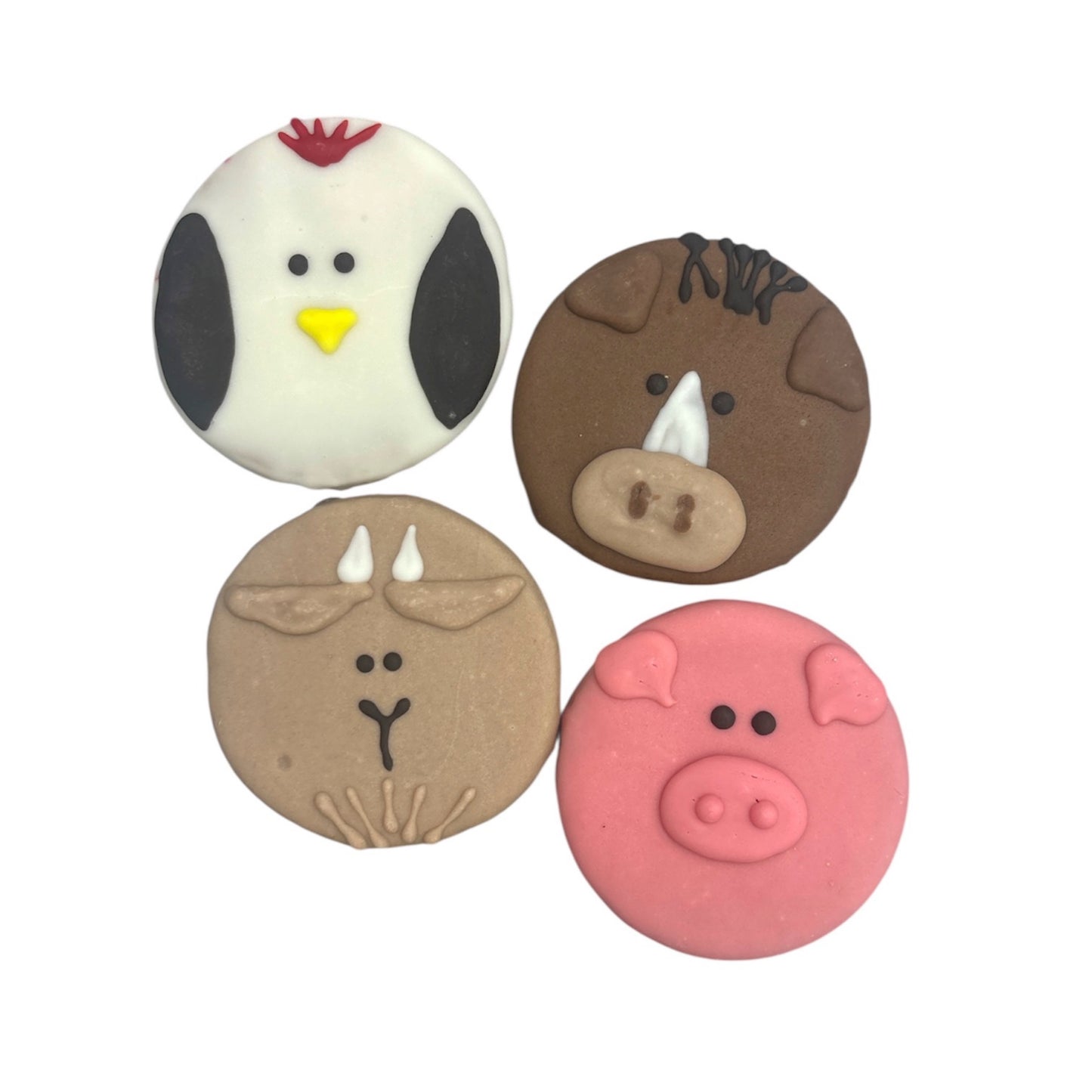 Four round animal-themed cookies: a white chicken, a brown horse, a tan goat, and a pink pig