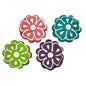 Four flower-shaped cookies with white icing, in pink, teal, green, and purple
