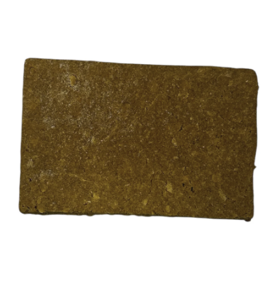 Rectangular block of solid brown material with a textured surface