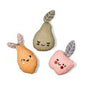 Three soft fabric toys shaped like a pear, an orange fruit, and a pink apple, each with embroidered faces