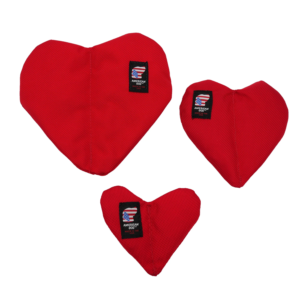 Three red heart-shaped dog toys in varying sizes, each with an American Dog brand label