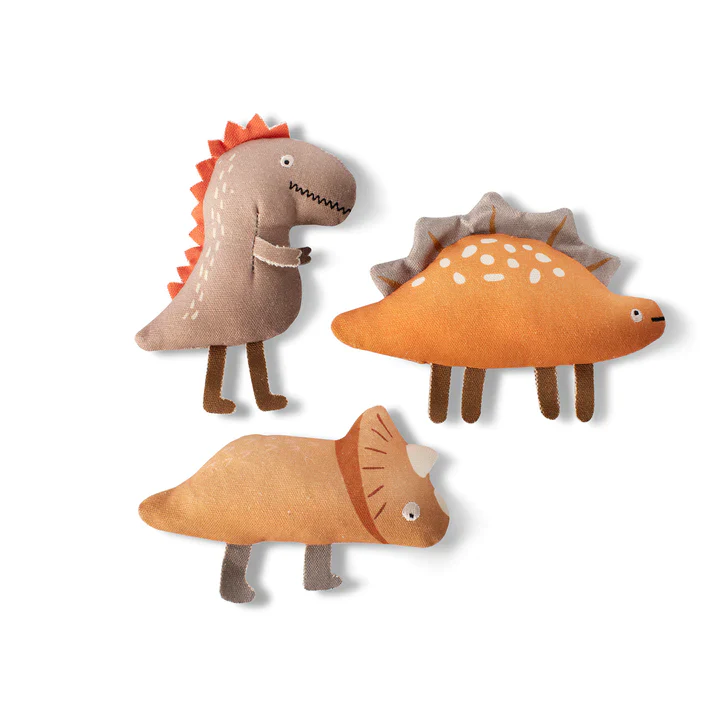 Three fabric dinosaur toys, a brown T-Rex, an orange Stegosaurus, and a brown Triceratops