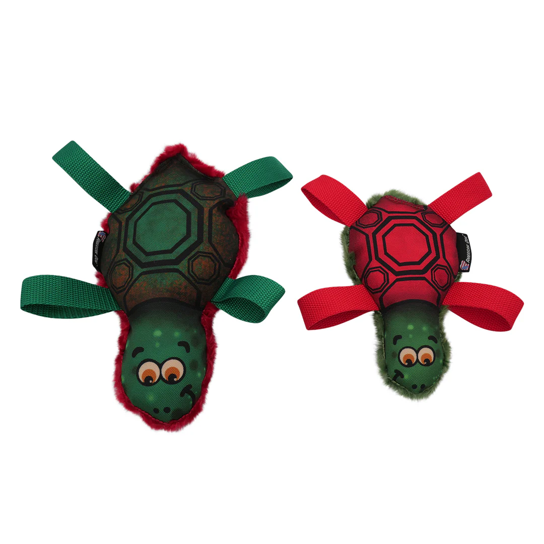 Two turtle-shaped dog toys, one green and one red, with fabric legs and plush trim