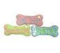 Three bone-shaped dog treats with pastel icing, labeled Nail Trim, Pawdicure, and Spa Day
